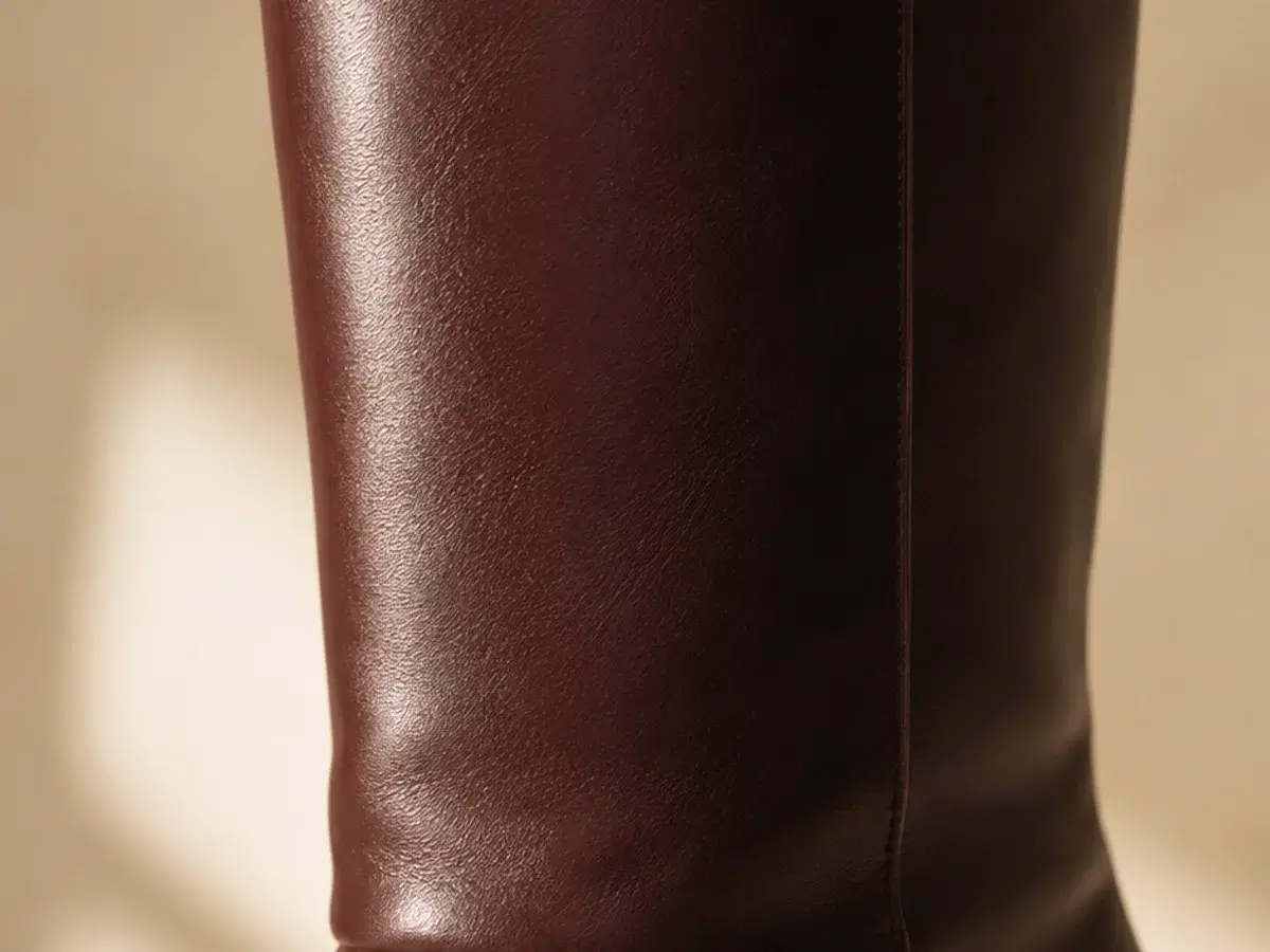 Macro detail of the smooth burgundy shaft and slim self-covered stiletto heel