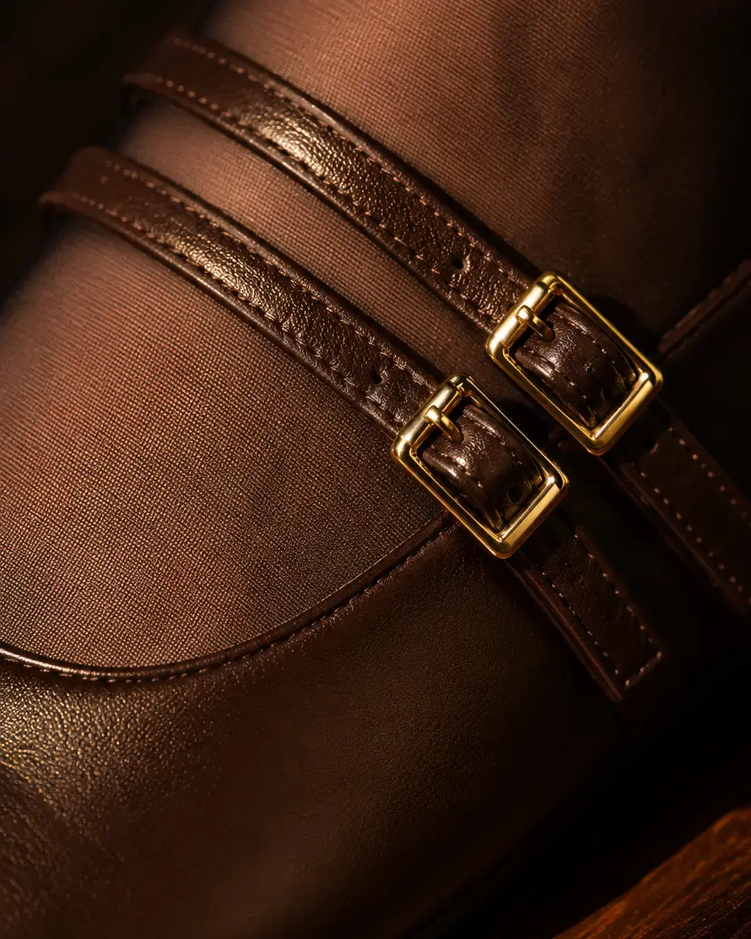 Macro of the twin gold buckles and parallel straps across the instep