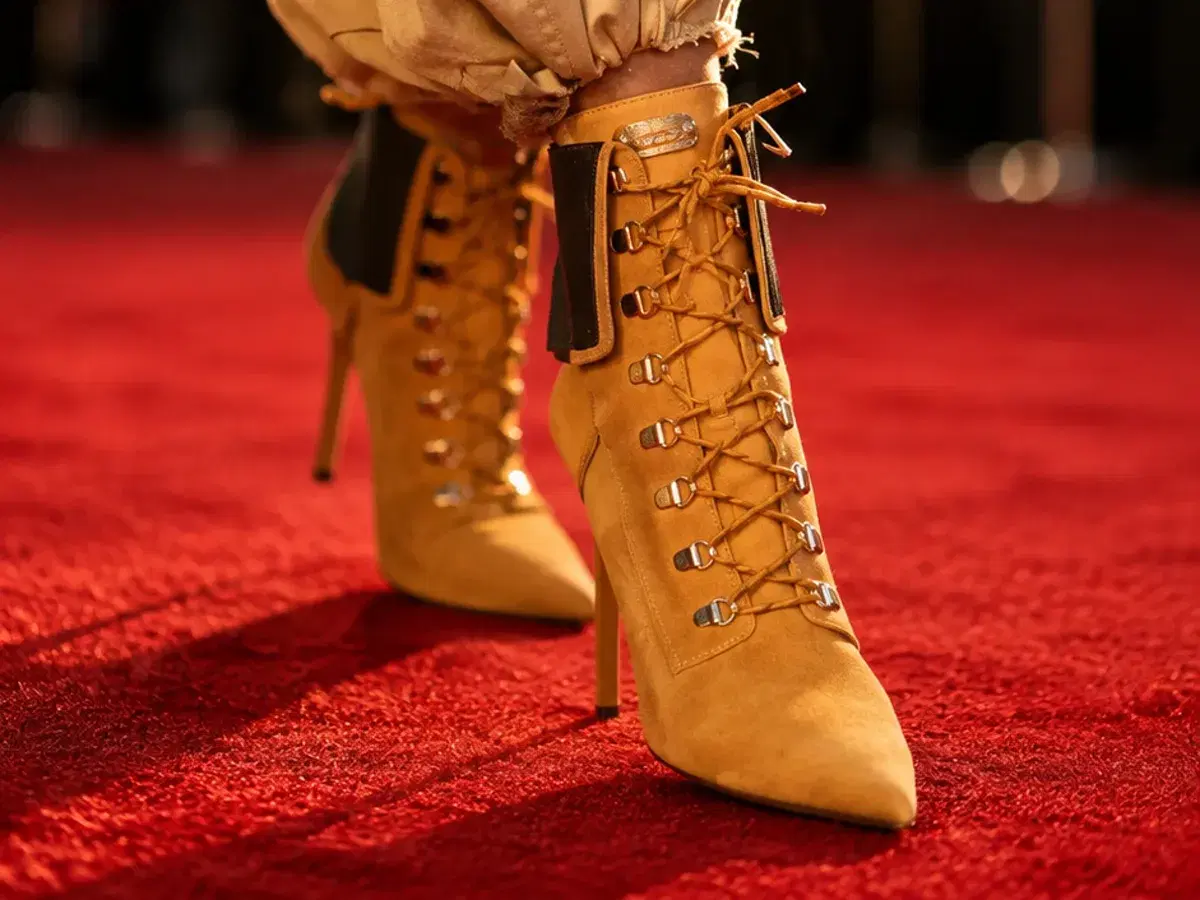 Wheat nubuck stiletto work boots photographed on a red carpet