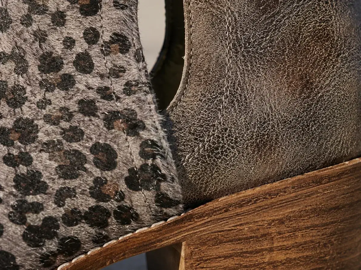 Close view of the seam where leopard calf hair meets distressed leather